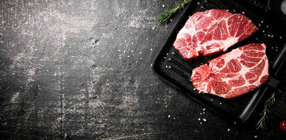 raw-pork-steak-on-a-grill-pan-2022-02-24-15-57-36-utc